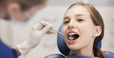 Young girl receiving dental treatment
